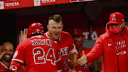 Angels catcher Kurt Suzuki (24) is greeted by center fielder Mike Trout (27) after hitting a two run home run against the Texas Rangers during the seventh inning at Angel Stadium on Apr 20, 2021.