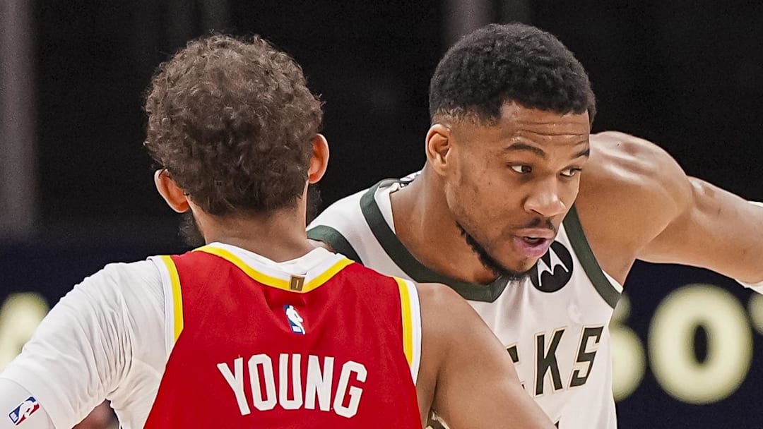 Mar 4, 2025; Atlanta, Georgia, USA; Milwaukee Bucks forward Giannis Antetokounmpo (34) reacts with Atlanta Hawks guard Trae Young (11) after the Bucks defeated the Hawks at State Farm Arena. Mandatory Credit: Dale Zanine-Imagn Images