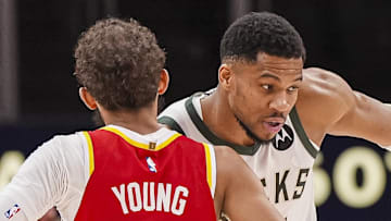 Mar 4, 2025; Atlanta, Georgia, USA; Milwaukee Bucks forward Giannis Antetokounmpo (34) reacts with Atlanta Hawks guard Trae Young (11) after the Bucks defeated the Hawks at State Farm Arena. Mandatory Credit: Dale Zanine-Imagn Images