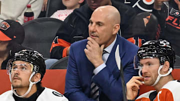 Oct 13, 2025; Philadelphia, Pennsylvania, USA; Philadelphia Flyers head coach Rick Tocchet with right wing Travis Konecny (11) and center Sean Couturier (14) against the Florida Panthers during the first period at Wells Fargo Center. Mandatory Credit: Eric Hartline-Imagn Images