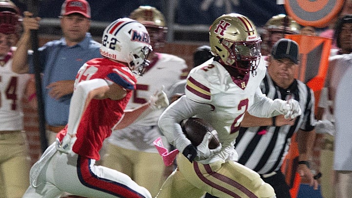 With an MRA defender at his heals, Hartfield's Bralan Womack (2) carries for yardage in Madison, Miss., Friday, Oct. 11, 2024.