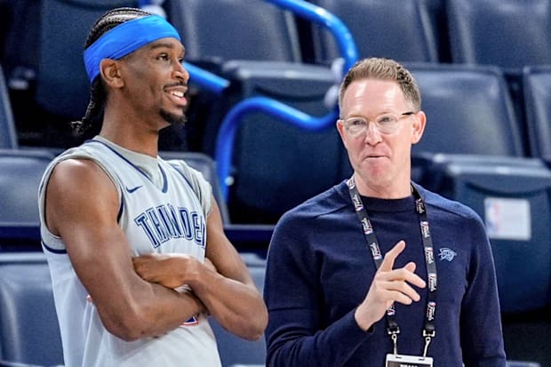OKC general manager Sam Presti and guard Shai Gilgeous-Alexander talk prior to a game.