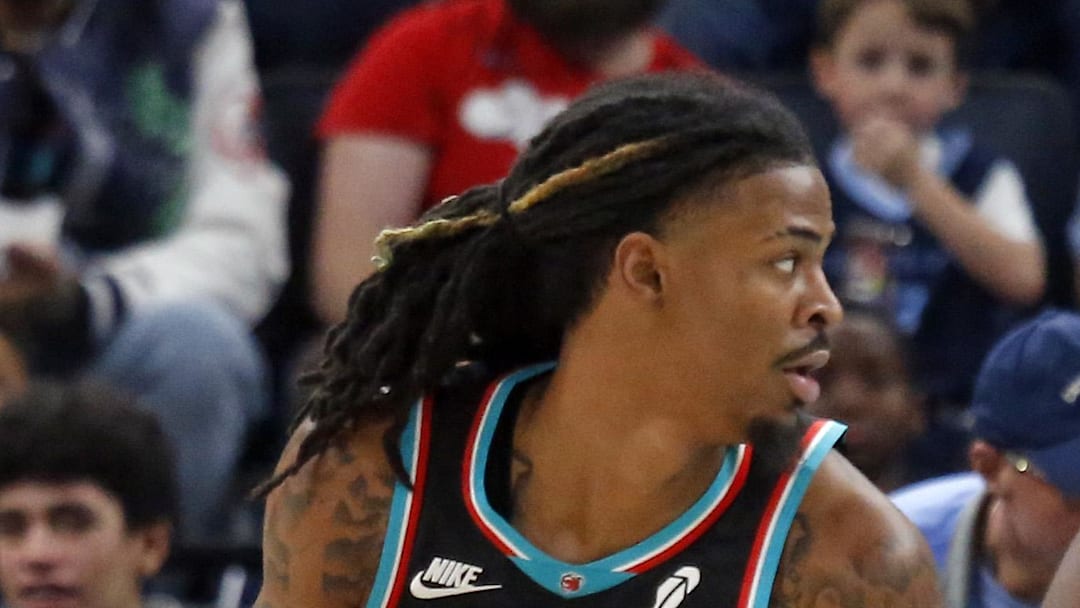Memphis Grizzlies guard Ja Morant dribbles as Oklahoma City Thunder guard Cason Wallace defends.