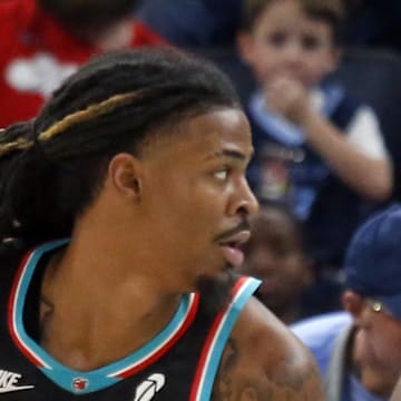 Memphis Grizzlies guard Ja Morant dribbles as Oklahoma City Thunder guard Cason Wallace defends.