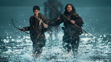 Jamie (Aaron Taylor-Johnson) and his son Spike (Alfie Williams) being chased by a Berserker in Columbia Pictures' 28 YEARS LATER. 