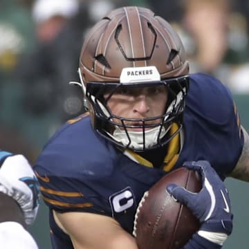Green Bay Packers tight end Tucker Kraft (85) runs on a catch against Carolina Panthers safety Nick Scott on Sunday.
