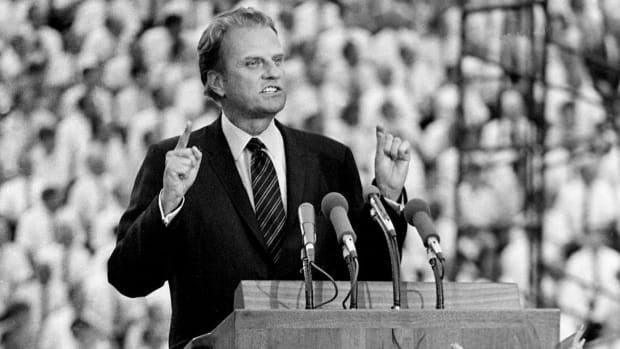 Evangelist Billy Graham speaks to a crowd at Tennessee's Neyland Stadium.