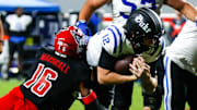 Nov 9, 2024; Raleigh, North Carolina, USA; North Carolina State Wolfpack cornerback Devon Marshall (16) tackles Duke Blue Devils quarterback Grayson Loftis (12) during the second half of the game at Carter-Finley Stadium. Mandatory Credit: Jaylynn Nash-Imagn Images