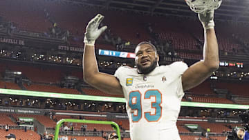 Dec 29, 2024; Cleveland, Ohio, USA; Miami Dolphins defensive tackle Calais Campbell (93) celebrates as he leaves the field following the win against the Cleveland Browns at Huntington Bank Field. 