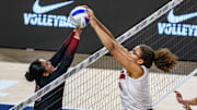 Nebraska's Rebekah Allick fights to get the ball over the net with a Stanford defender. 