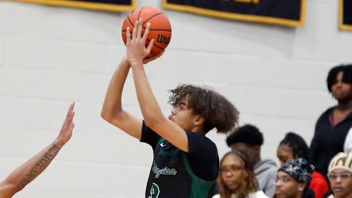 South Bend Washington sophomore Steven Reynolds III, right, shoots a '3' over South Bend Riley senior Payton Baird during a boys basketball game Thursday, Feb. 1, 2024, at Riley High School.