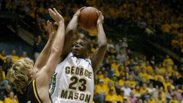 George Mason guard John Vaughan attempts a layup over Wichita State.
