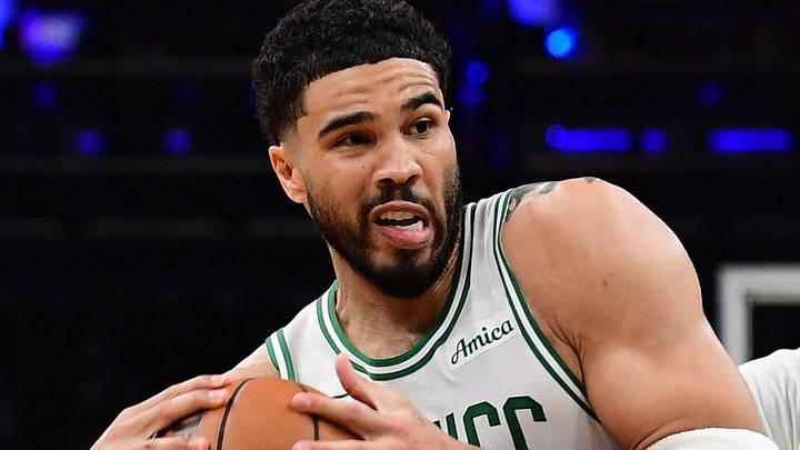 Apr 19, 2026; Boston, Massachusetts, USA; Boston Celtics forward Jayson Tatum (0) drives to the basket between Philadelphia 76ers forward Paul George (8) and center Andre Drummond (1) in the second half during game one of the first round of the 2026 NBA Playoffs at TD Garden. Mandatory Credit: Bob DeChiara-Imagn Images