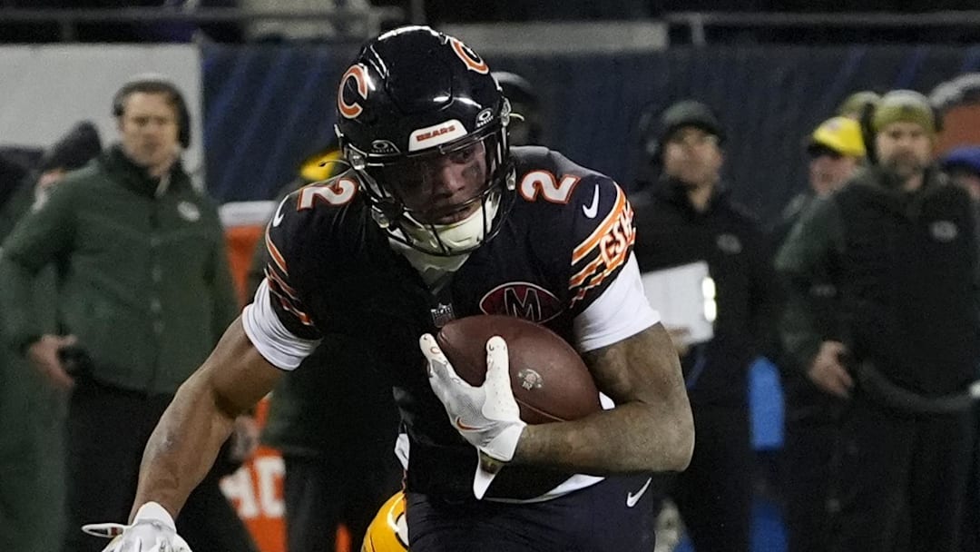 Jan 10, 2026; Chicago, IL, USA;  Chicago Bears wide receiver DJ Moore (2) runs after the catch as Green Bay Packers safety Evan Williams (33) defends during the first half of an NFC Wild Card Round game at Soldier Field. Mandatory Credit: David Banks-Imagn Images