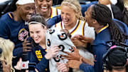 The Indiana Fever celebrate Indiana Fever guard Caitlin Clark during a preseason against the Brazil national team.