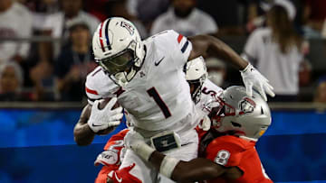 Aug 31, 2024; Tucson, Arizona, USA; Arizona Wildcats running back Jacory Croskey-Merritt (1) gets tackled by New Mexico Lobos safety Christian Ellis (8) during first quarter at Arizona Stadium. Mandatory Credit: Aryanna Frank-Imagn Images