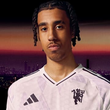 Leny Yoro modeling Manchester United's away shirt for the upcoming season.