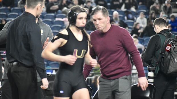 University's Libby Roberts gets last-minute instruction from her father, Kevin, before winning the Class 3A girls 110-pound t