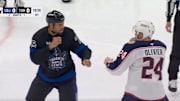 Toronto Maple Leafs' Ryan Reaves and Columbus Blue Jackets' Mathieu Olivier drop gloves.