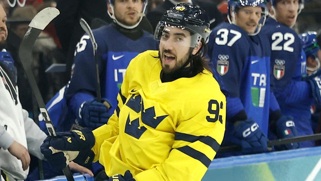Feb 11, 2026; Milan, Italy; Mika Zibanejad of Sweden celebrates scoring their fourth goal as Italy players look on in men's ice hockey group B play during the Milano Cortina 2026 Olympic Winter Games at Milano Santagiulia Ice Hockey Arena. Mandatory Credit: Geoff Burke-Imagn Images