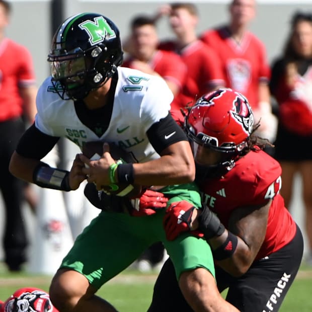 Marshall Thundering Herd quarterback Cam Fancher (14) is sacked by North Carolina State Wolfpack.