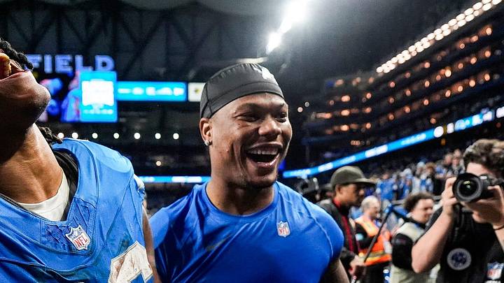 Detroit Lions running back Jahmyr Gibbs (26) and running back David Montgomery (5) celebrate 34-31 win over Green Bay Packers as he exits the field at Ford Field in Detroit on Thursday, Dec. 5, 2024.