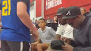 Anthony Edwards signs an autograph for a fan. 