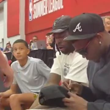 Anthony Edwards signs an autograph for a fan. 