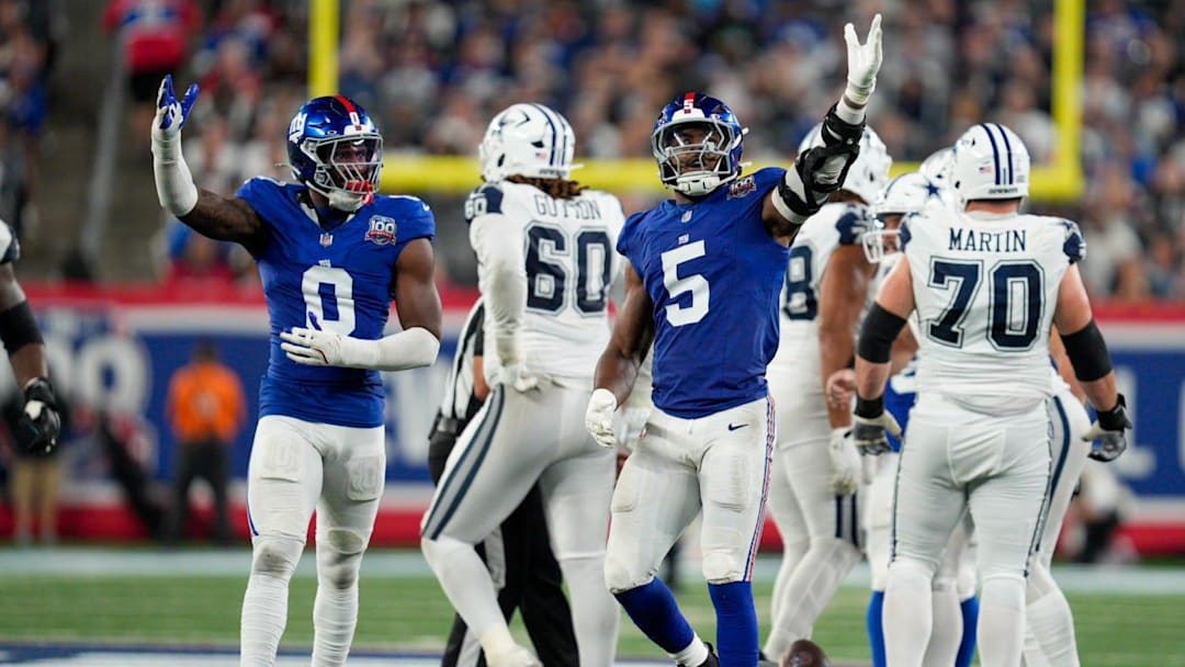 Sep 26, 2024; East Rutherford, NJ, US; New York Giants linebacker Brian Burns (0) and New York Giants linebacker Kayvon Thibodeaux (5) celebrate after sacking Dallas Cowboys quarterback Dak Prescott (4) at MetLife Stadium. Sep 26, 2024; East Rutherford, NJ, US; New York Giants linebacker Brian Burns (0) and New York Giants linebacker Kayvon Thibodeaux (5) celebrate after sacking Dallas Cowboys quarterback Dak Prescott (4) at MetLife Stadium.