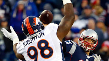 Nov 2, 2014; Foxborough, MA, USA; New England Patriots quarterback Tom Brady (12) throws past Denver Broncos defensive tackle Terrance Knighton (98) during the first quarter at Gillette Stadium. Mandatory Credit: Winslow Townson-Imagn Images