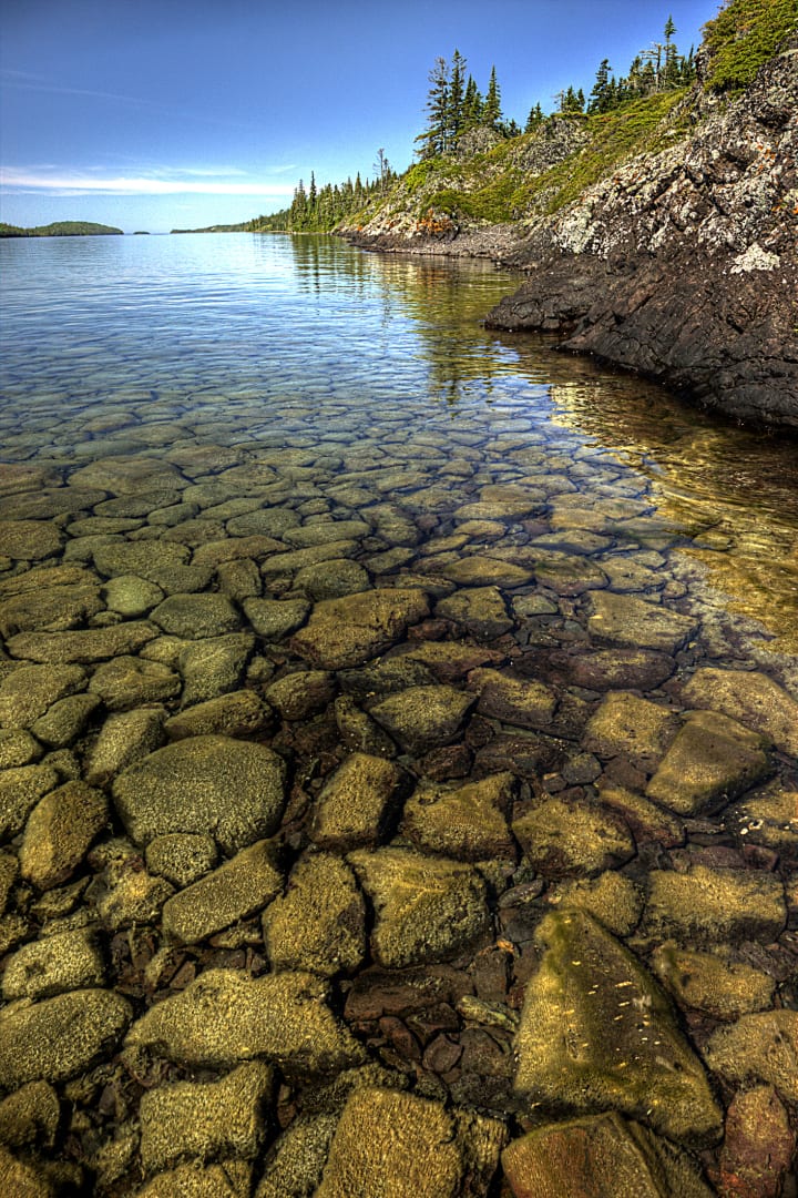 Cobblestones under crystal clear water fit together like a puzzle in Isle Royale National Park.