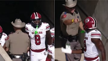 A state trooper walks into South Carolina players in the tunnel during a game at Texas A&M.