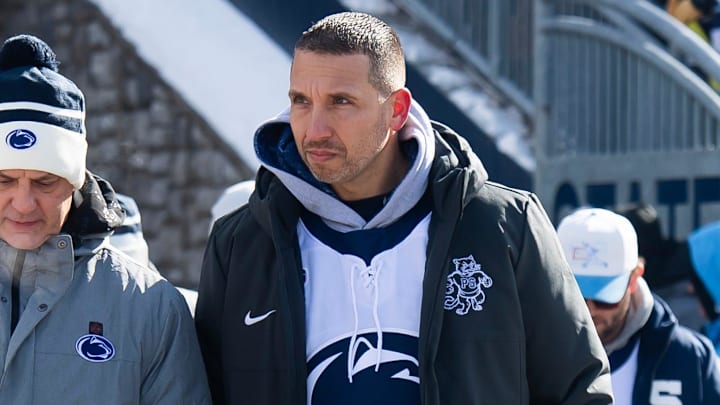 First-year Penn State football head coach Matt Campbell, right, walks into Beaver Stadium for a top-five Big Ten ice hockey game against Michigan State in Beaver Stadium on January 31, 2026, in State College.
