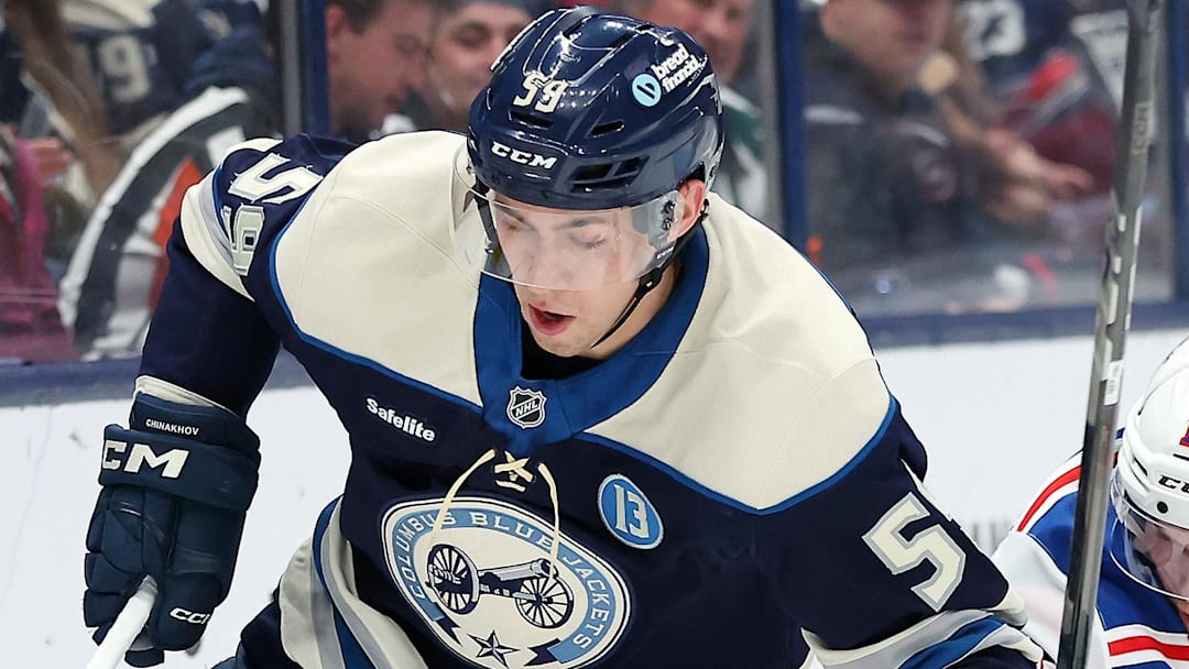 Mar 15, 2025; Columbus, Ohio, USA;  Columbus Blue Jackets right wing Yegor Chinakhov (59) controls the puck as New York Rangers defenseman Urho Vaakanainen (18) defends during the second period at Nationwide Arena. Mandatory Credit: Joseph Maiorana-Imagn Images