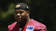 Washington Commanders defensive tackle Daron Payne stands on the field on day one of minicamp at Commanders Park