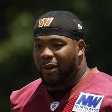 Washington Commanders defensive tackle Daron Payne stands on the field on day one of minicamp at Commanders Park