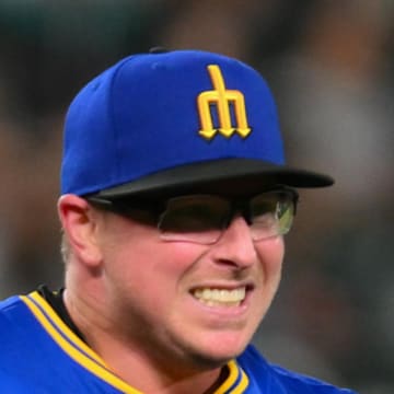 Seattle Mariners relief pitcher Trent Thornton (46) holds his ankle after falling down during the ninth inning against the Texas Rangers at T-Mobile Park on July 31. 