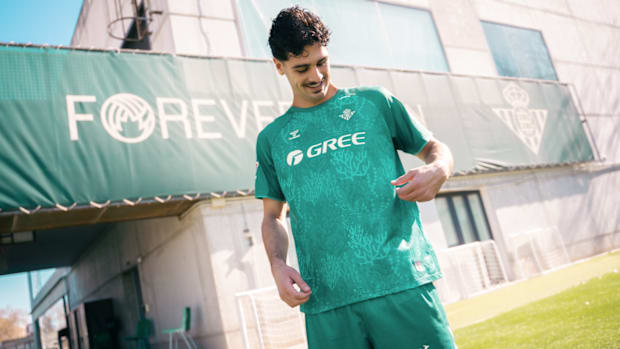 USMNT midfielder Johnny Cardoso showcases a new Real Betis shirt. 