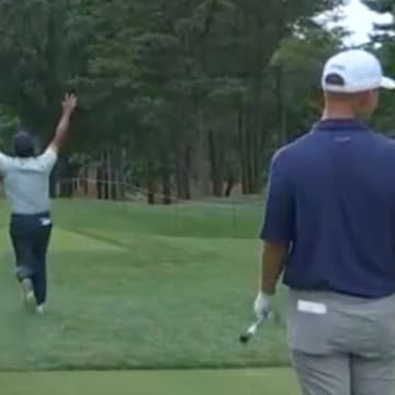 Si Woo Kim celebrates making a hole in one at the PGA Championship.