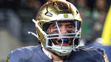 Notre Dame Fighting Irish linebacker Drayk Bowen (34) celebrates a defensive stop with safety Adon Shuler (8) during the first half.