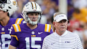 Sep 24, 2022; Baton Rouge, Louisiana, USA; LSU Tigers head coach Brian Kelly looks on with quarterback Garrett Nussmeier (13) and quarterback George Hamsley (16) and safety Sage Ryan (15) during warmups before the game against the New Mexico Lobos at Tiger Stadium. Mandatory Credit: Stephen Lew-Imagn Images