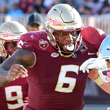 Nov 2, 2024; Tallahassee, Florida, USA;  Florida State Seminoles defensive tackle Darrell Jackson Jr (6) pursues North Carolina Tarheels running back Davion Gause (21) in the second quarter at Doak S. Campbell Stadium. Mandatory Credit: Robert Myers-Imagn Images