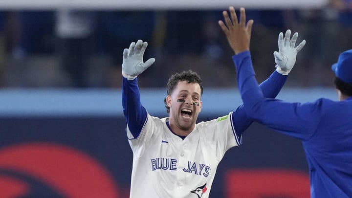 Jul 26, 2024; Toronto, Ontario, CAN; Toronto Blue Jays third baseman Ernie Clement (28) celebrates his walk off single to win the game against he Texas Rangers in the ninth inning at Rogers Centre. Mandatory Credit: John E. Sokolowski-USA TODAY Sports