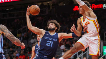 Oct 12, 2023; Atlanta, Georgia, USA; Memphis Grizzlies forward David Roddy (21) grabs a rebound past Atlanta Hawks forward Jalen Johnson (1) in the first half at State Farm Arena. Mandatory Credit: Brett Davis-USA TODAY Sports