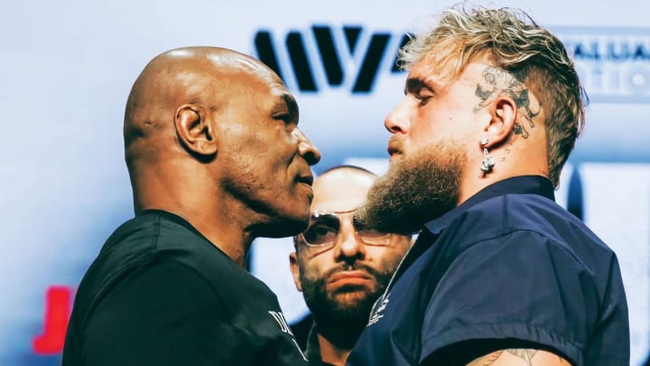 At the press conference, Mike Tyson and Jake Paul exchange playful shoves, hyping up their highly anticipated bout