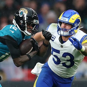 [US, Mexico & Canada customers only] Oct 19, 2025; London, United Kingdom; Jacksonville Jaguars wide receiver Travis Hunter (12) runs with the ball against Los Angeles Rams safety Kamren Kinchens (26) and linebacker Nate Landman (53) during the second half during a NFL International Series game at Wembley Stadium. Mandatory Credit: Andrew Boyers-Reuters via Imagn Images