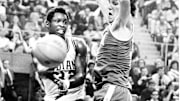 Indiana's Steve Downing passes the ball around UCLA's Bill Walton during the 1973 Final Four semifinal between the Hoosiers and Bruins. UCLA won 70-59.