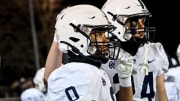 East Lansing's Jace Clarizio is congratulated by teammate Ethan Shipley, right, during the fourth quarter in the game against Grand Ledge on Friday, Oct. 20, 2023, at Grand Ledge High School.