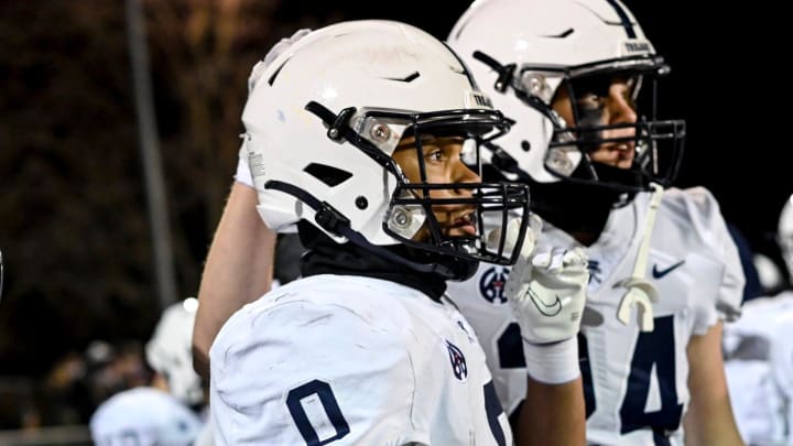 East Lansing's Jace Clarizio is congratulated by teammate Ethan Shipley, right, during the fourth quarter in the game against Grand Ledge on Friday, Oct. 20, 2023, at Grand Ledge High School.