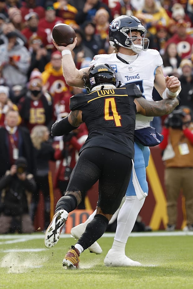 Tennessee Titans quarterback Will Levis passes the ball while being hit by Washington Commanders linebacker Frankie Luvu